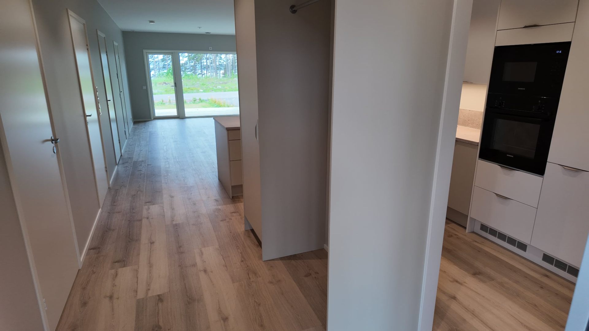 Hall med vy mot vardagsrum och kök i Kalmarstrand lägenhet